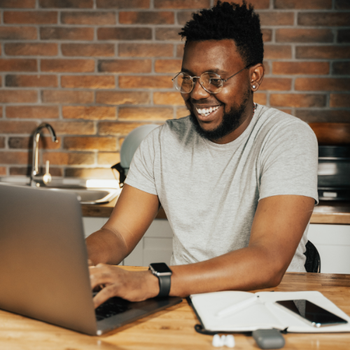 Man smiling at computer 500x500 1